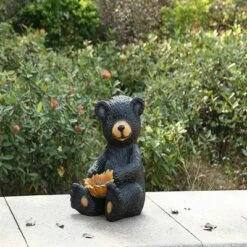Budget 🌟 HI-LINE GIFT LTD 13" Polyresin Sitting Bear Cub Holding Sunflower Outdoor Statue Black - Hi-Line Gift 🧨